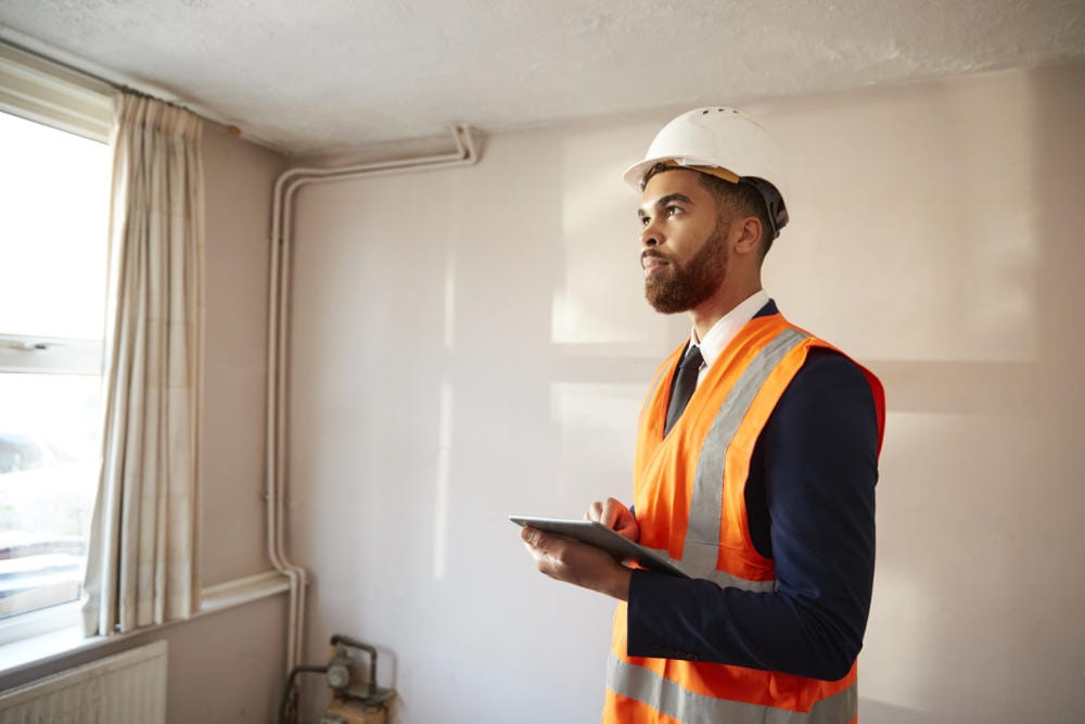 Surveyor in hard hat and high visibility jacket